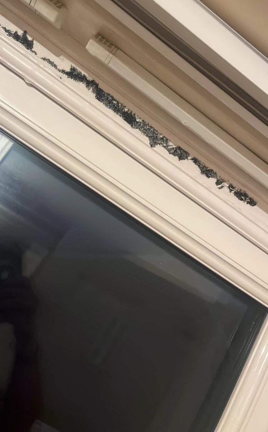 Before: White window frame cleaned of black marks
