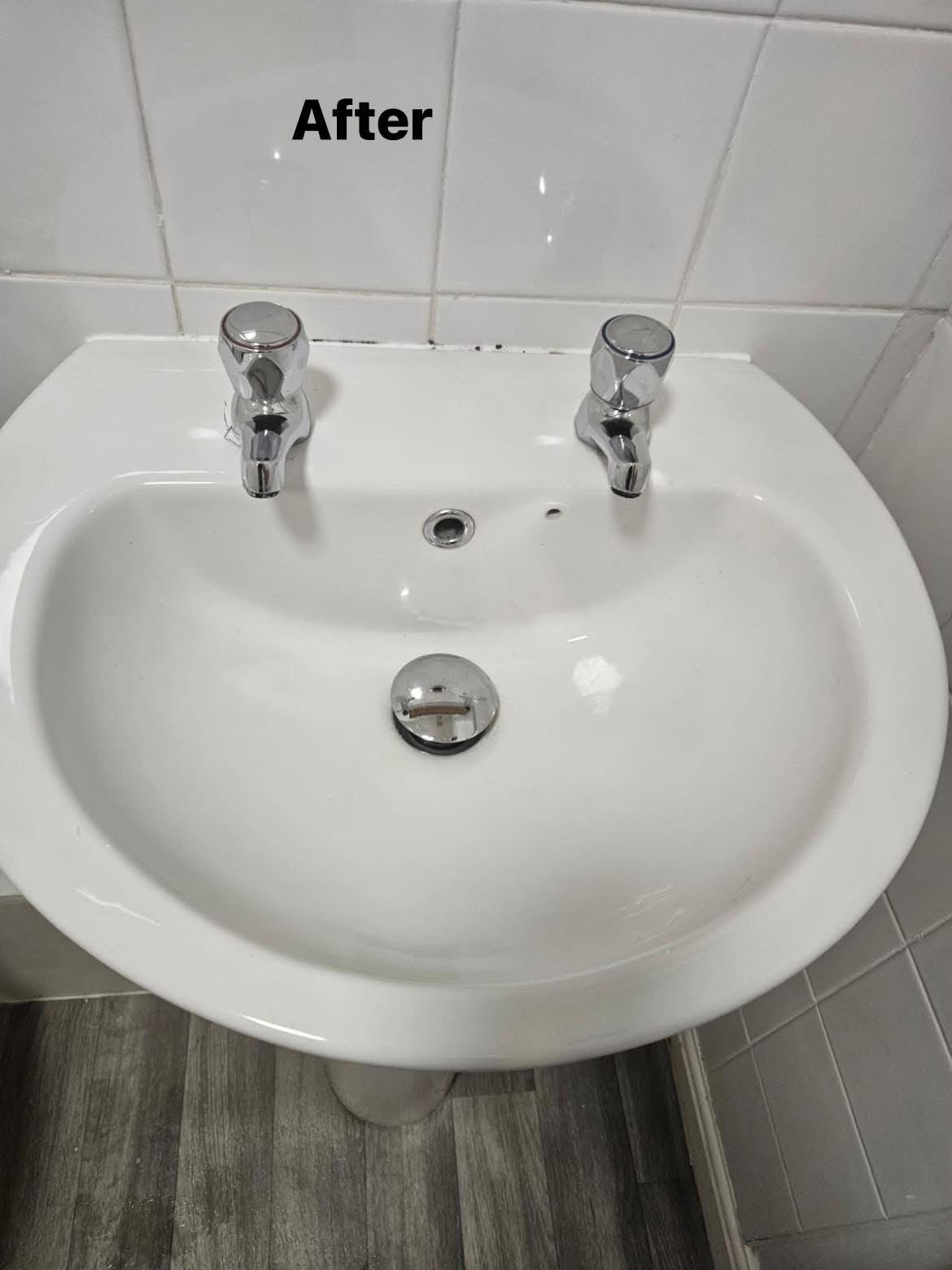 After: White bathroom sink and taps after cleaning