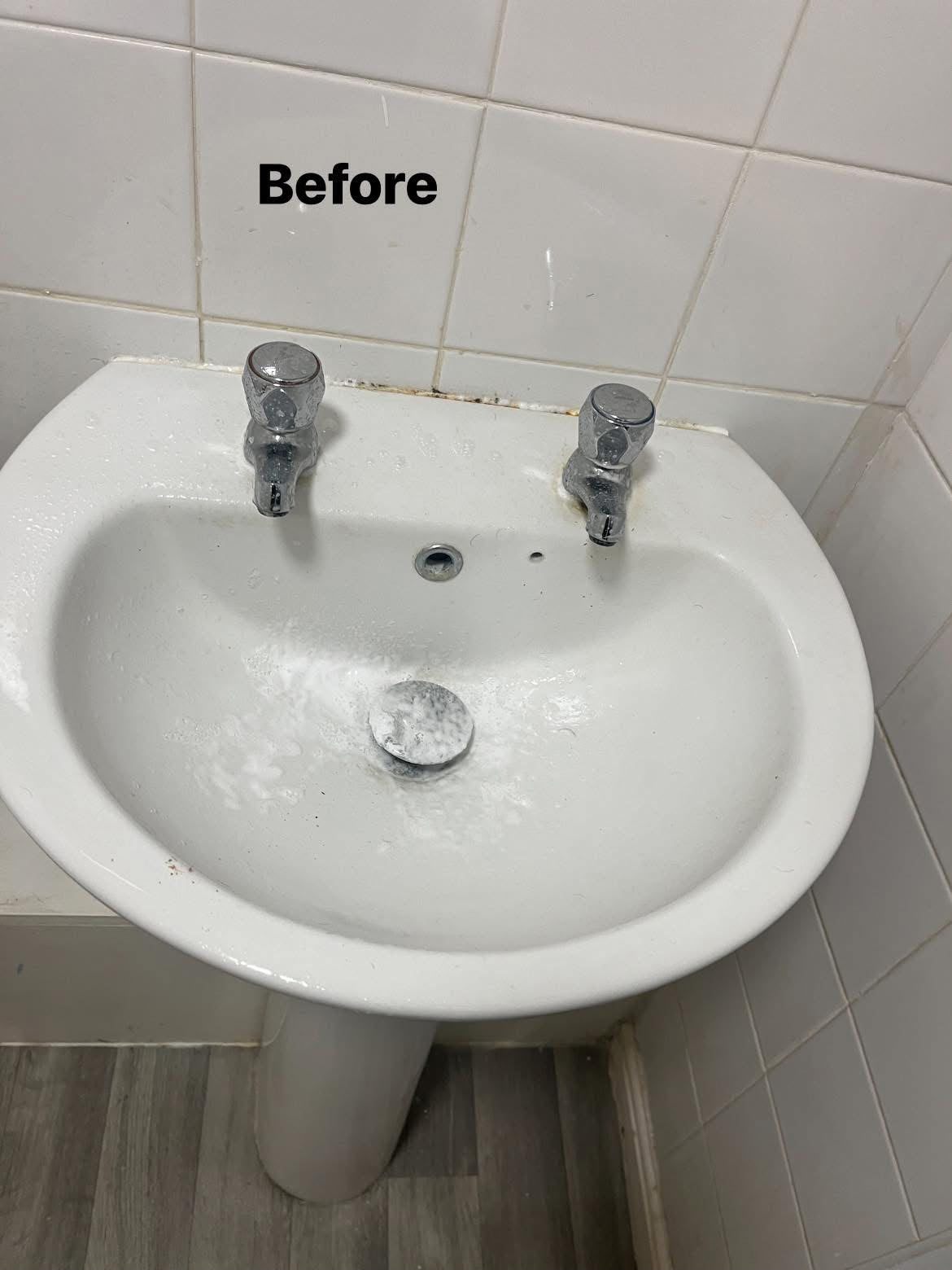 Before: White bathroom sink and taps after cleaning
