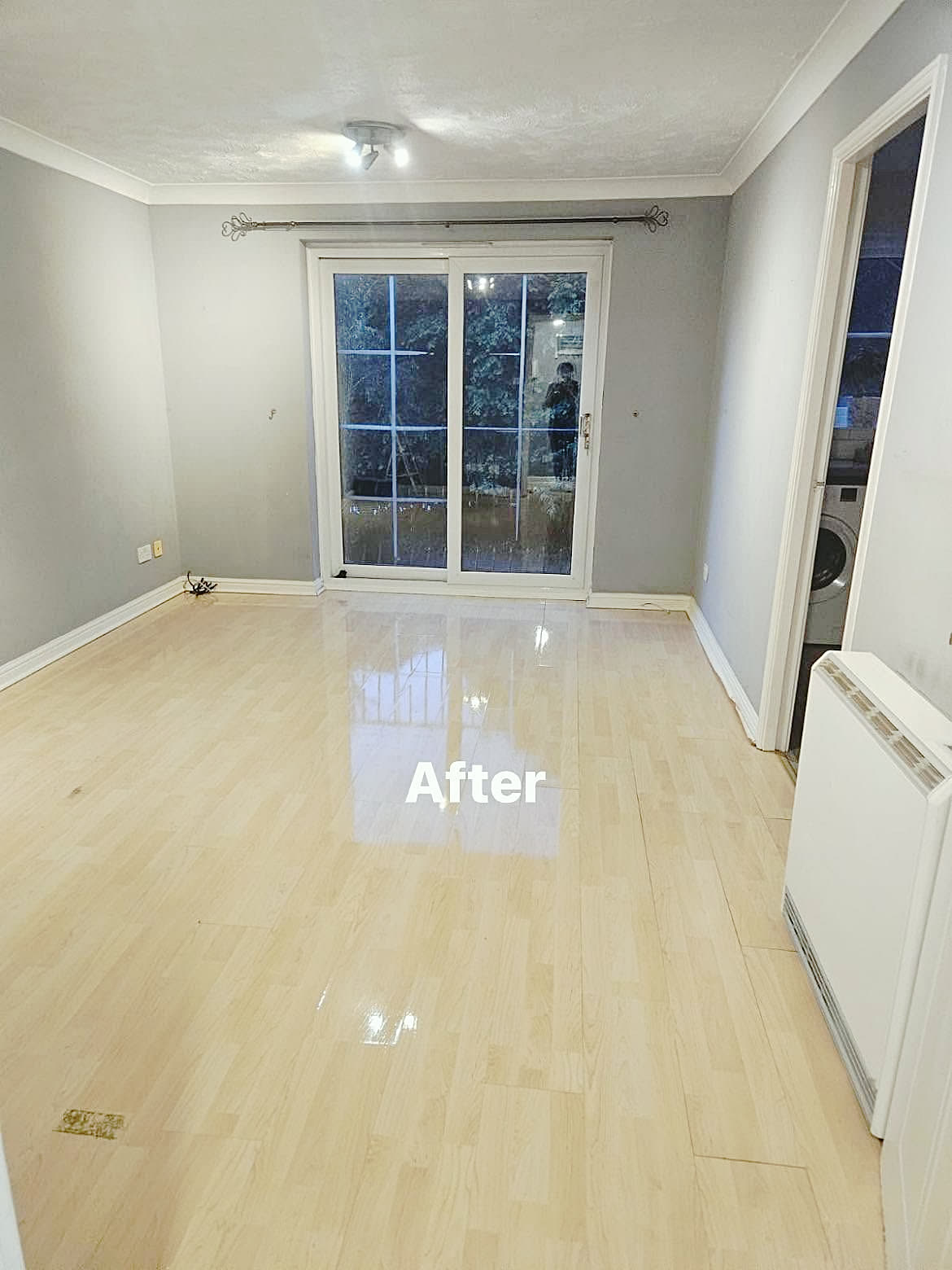 After: Shiny laminate floor in an empty living room