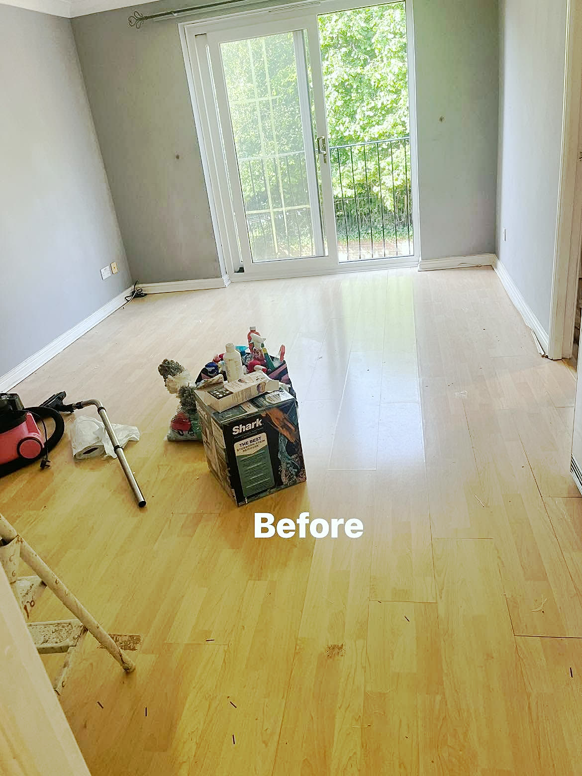 Before: Shiny laminate floor in an empty living room