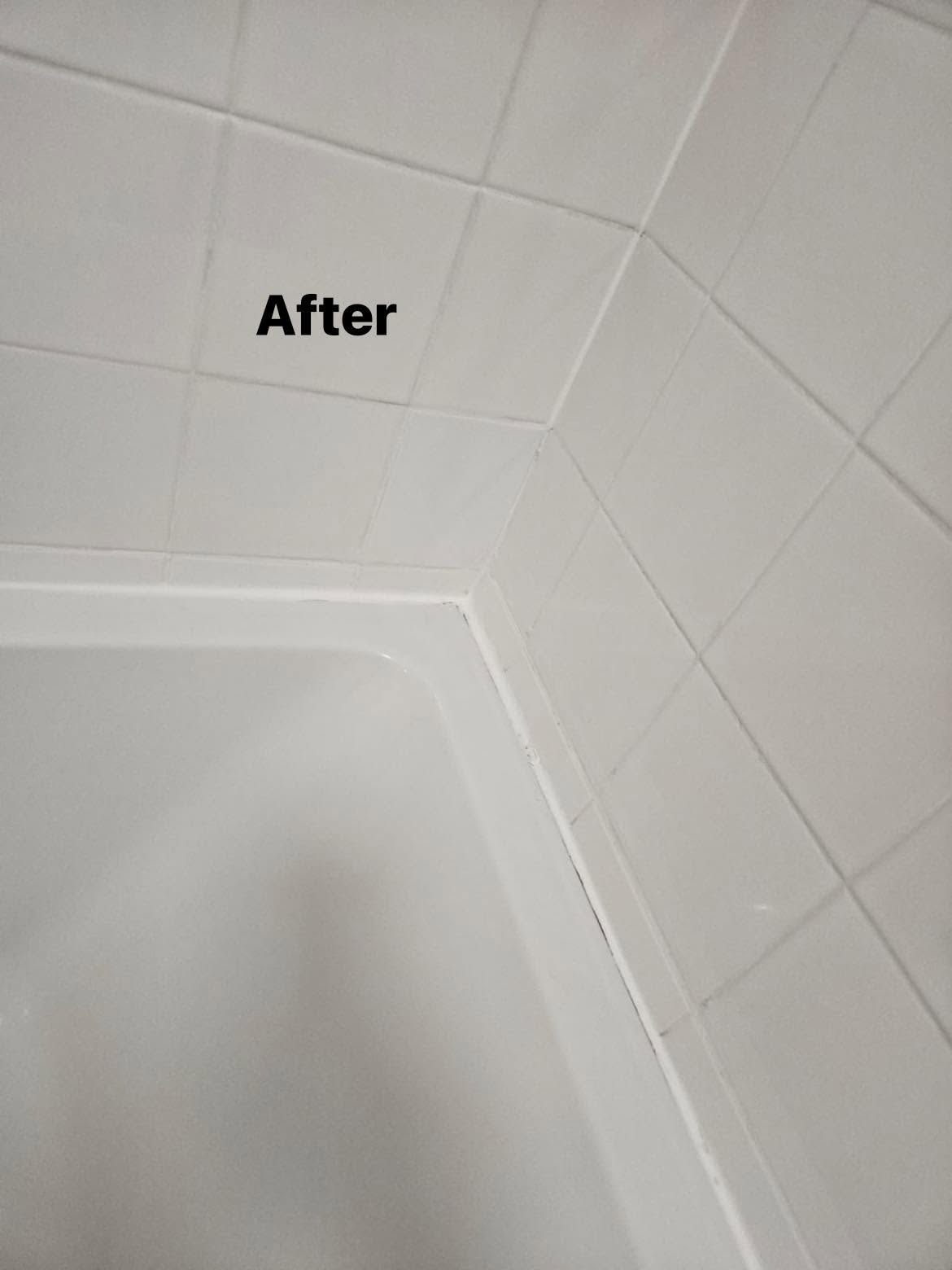 After: White bath and tiled wall after cleaning